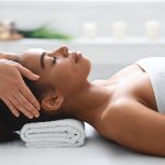 young-black-woman-getting-head-massage-from-massage-therapist.jpg